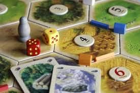 Playzokids Catan 6th Edition trade, build, and settle board game with colorful hex tiles and game pieces in the image.
