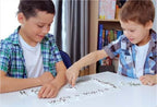Playzokids Ambassador MA Classic Games Dominoes set with black and white tiles on a wooden surface.