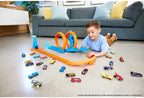 Hot Wheels toy car track set with triple loops and a 1:64 scale car on a colorful racing track.