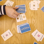 Playzokids Anomia card game for adults, kids, and families, featuring colorful game cards on a table.