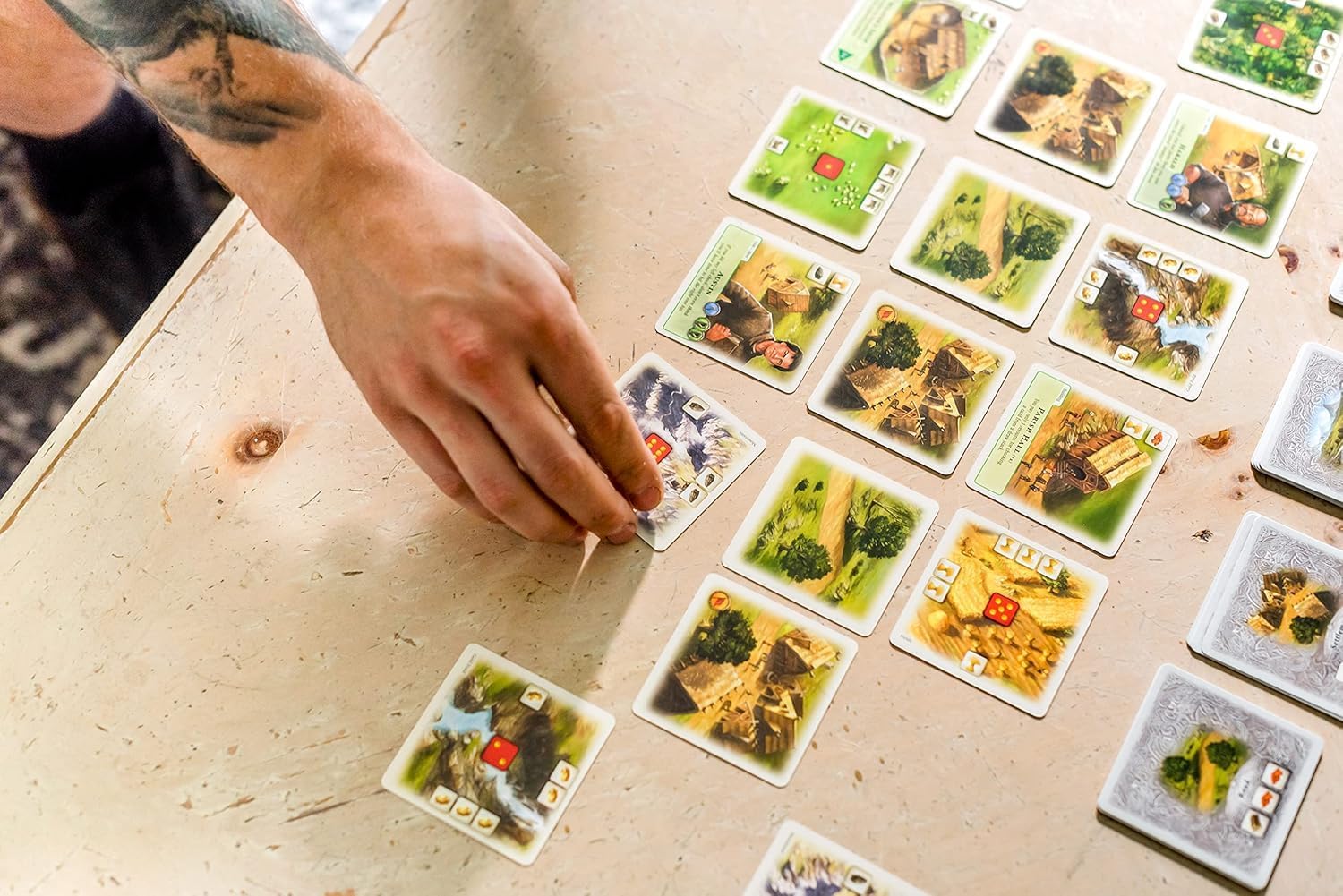 Catan Rivals board game by Playzokids featuring a game setup with colorful tokens and cards for two players, ages 10 and up.