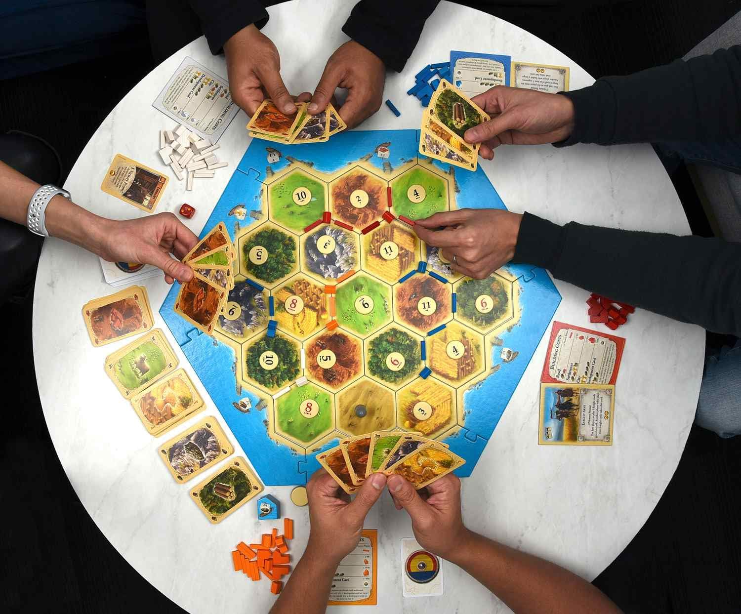 Playzokids Catan 6th Edition trade and build Settlers of Catan board game with colorful game pieces on the game board.