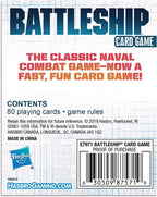 Hasbro Gaming Classic Battleship card game with colorful game pieces and playing cards on a wooden surface