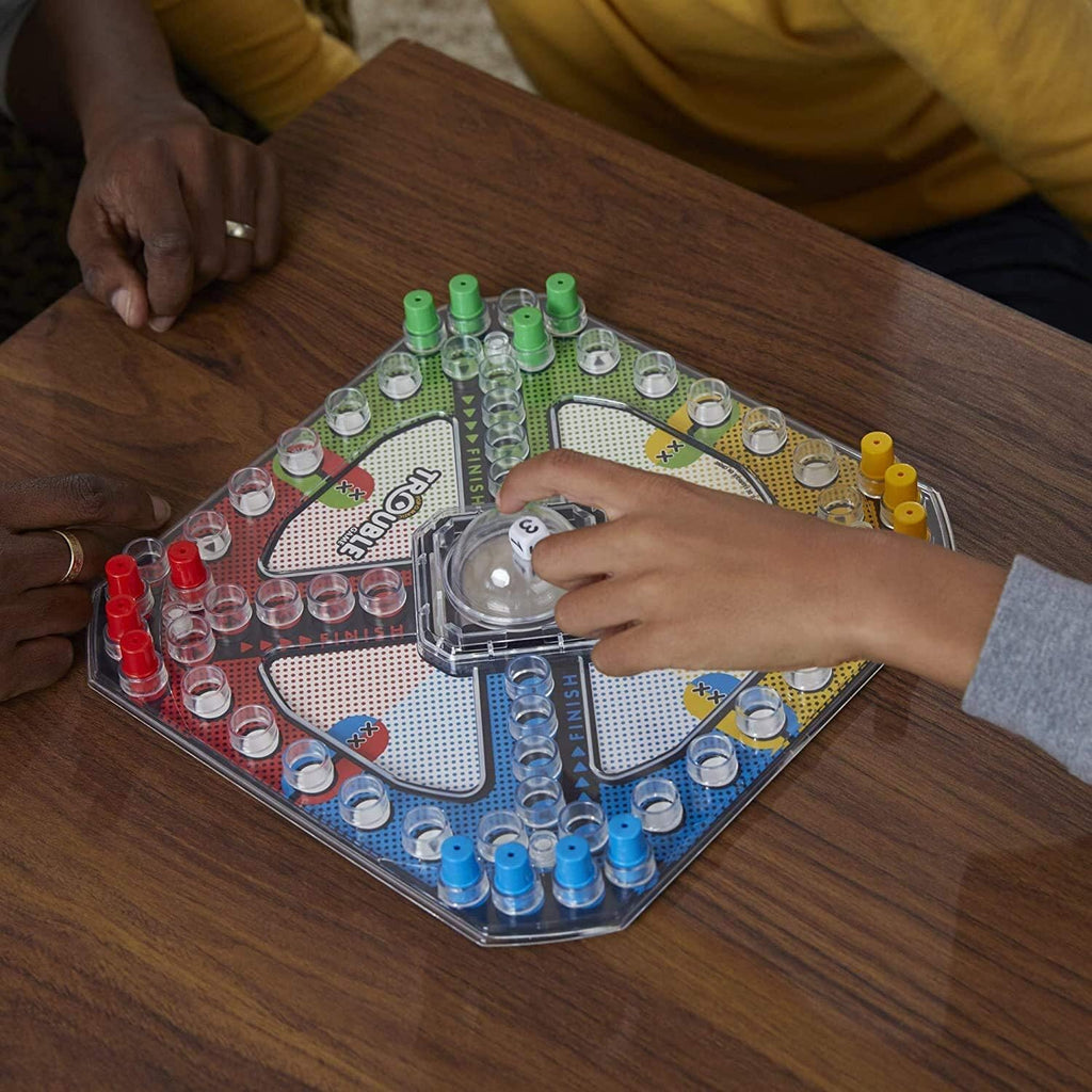 Hasbro Trouble board game with colorful game board, pop-o-matic dice roller, and game pieces for family fun.