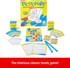 Mattel Pictionary board game with game cards, drawing pad, and game pieces on a wooden table.