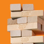 Hasbro Official Jenga game with wooden blocks stacked in a tower for a balancing game.